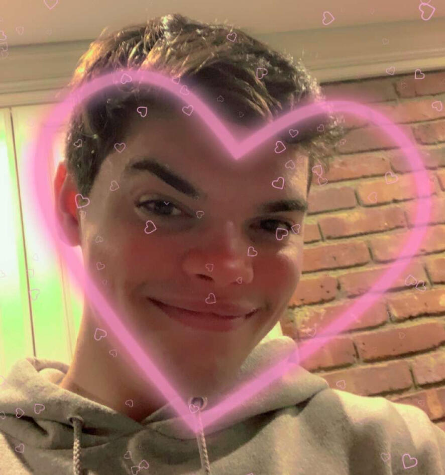 Treverse standing on a beach in a raggedy suit.