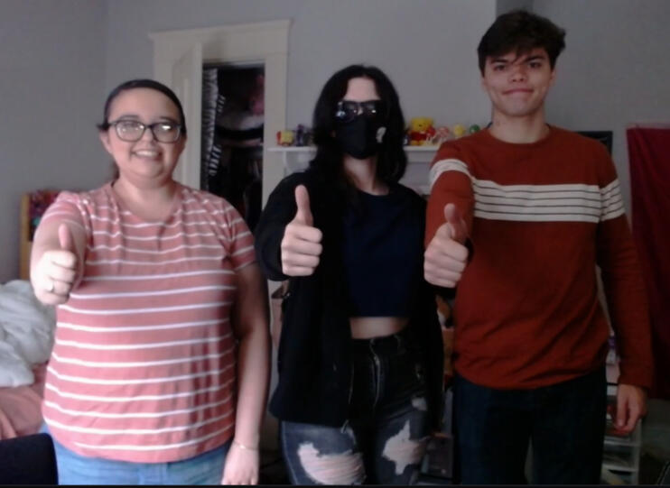 Treverse and his friends giving a thumbs-up at the camera.